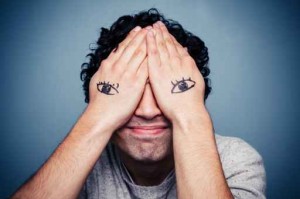 Man with eyes painted on his hands