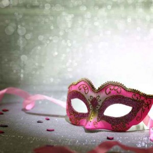 Pink carnival mask with glittering background